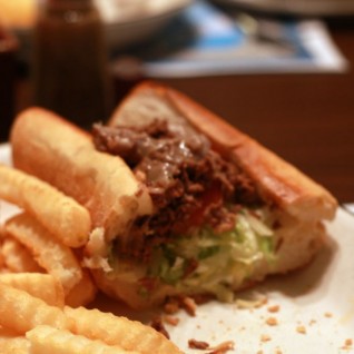 Steak and Cheese sandwich with fries at a tipbomb